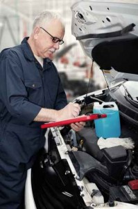 Auto mechanic checking engine.